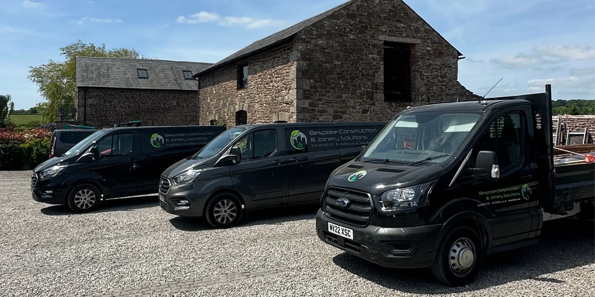 Bespoke Construction & Joinery Solutions fleet parked by an old building in Pontypool